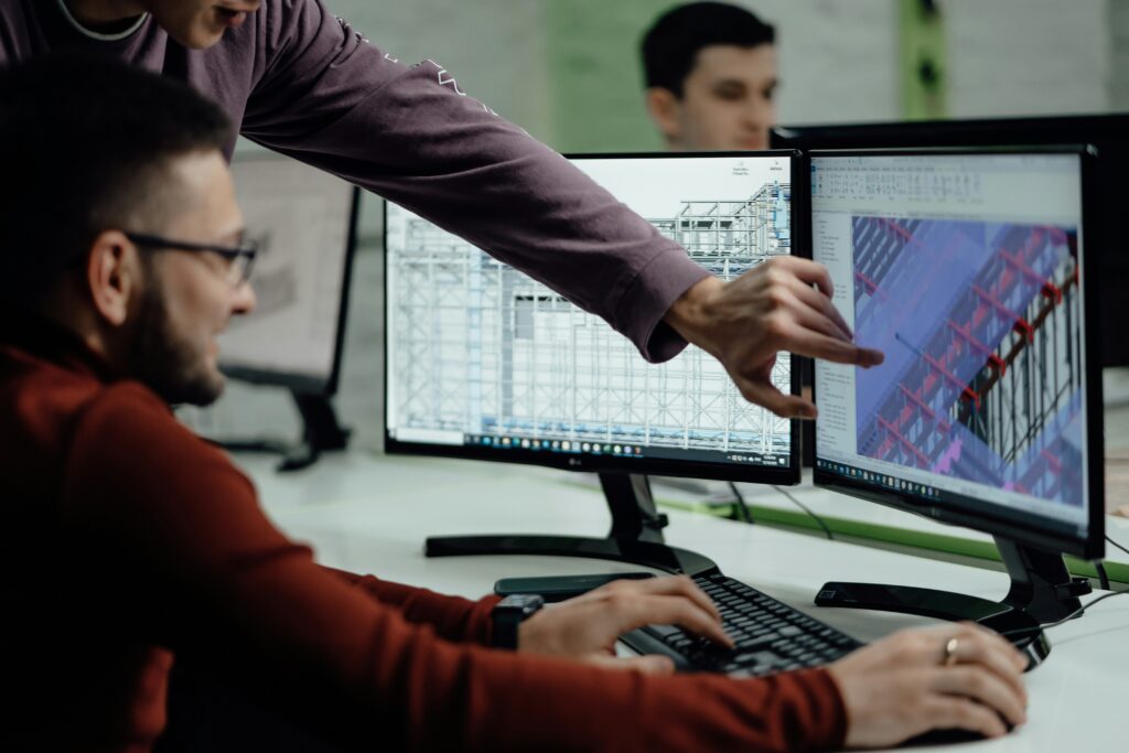 men looking on computer at BIM